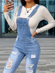 Women's slim-fit distressed denim overalls with ripped details and adjustable straps