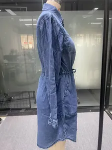 Side view of long-sleeved denim midi dress featuring adjustable drawstring waist and pockets