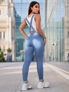 Rear view of stylish light blue slim-fit denim overalls for women with cross back straps