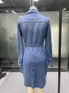 Detailed rear view of a long-sleeved medium wash denim shirt dress with waist-cinching.
