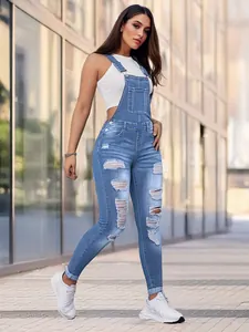 Full body shot of women's slim-fit ripped denim overalls worn by a model in urban street scene