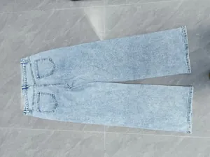 Detailed back view of high-waisted wide-leg light wash denim jeans with pockets.