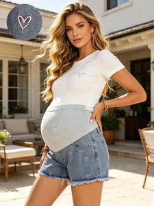 Detailed view of maternity denim shorts with embroidered hearts and belly support