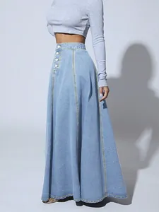 Detailed view of light blue denim maxi skirt with A-line cut and vertical stitching