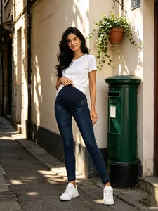 Detailed view of slim-fit maternity jeans with comfortable belly support in outdoor setting.