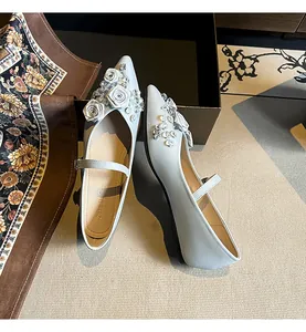 Elegant pointed-toe Mary Jane shoes featuring delicate 3D floral and crystal embellishments