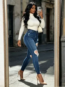 Jean skinny taille haute bleu foncé avec détails déchirés et ourlets effilochés