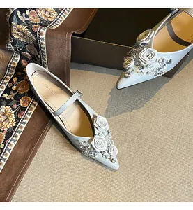 Elegant light blue pointed-toe Mary Jane flats with white roses and crystal details