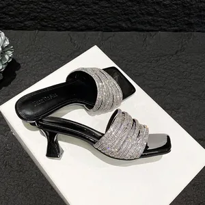 Elegant black high-heeled sandals with silver rhinestone straps in a stylish French design
