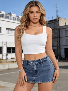 Detail view of a distressed denim mini skirt and white ribbed crop top outfit