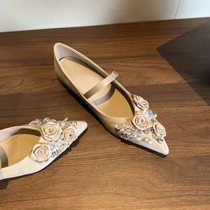 Champagne pointed-toe Mary Janes with floral and crystal decor, comfortable flats
