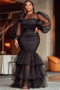Elegant black plus size dress with sheer polka dot puff sleeves and tiered ruffle hem.