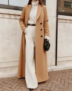 Elegant long camel wool coat styled with a white turtleneck and wide-leg trousers