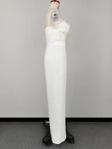 Detailed side profile of an elegant white feather bandeau jumpsuit on a professional dress form.