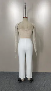 Back view of elegant white jumpsuit featuring a sequined beige tube top detail.