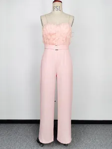 Pink strapless jumpsuit featuring elegant feather bust trim and a matching waist belt.