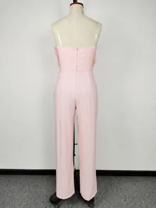 Detailed back view of a pink strapless jumpsuit featuring side feather trim on a mannequin