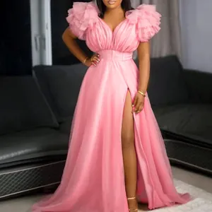 Elegant pink tulle maxi dress with ruffled sleeves and high slit for evening parties.