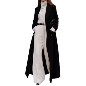 Elegant women's long black wool coat featured in a minimalist autumn winter fashion style.