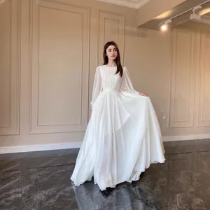 Elegant French style white chiffon maxi gown with long sheer sleeves and pleated bodice.