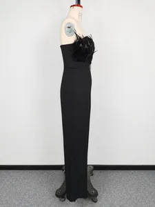 Detail side view of a black strapless jumpsuit featuring elegant feather trim on chest.