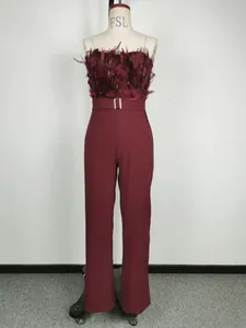 Full front view of an elegant wine red jumpsuit with feather bust detail on a mannequin