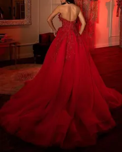 Elegant red strapless ball gown with sequin floral embroidery for formal events.