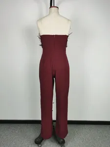 Back view of a fashionable burgundy feather trim strapless jumpsuit on a mannequin.