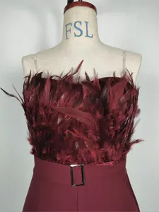 Detail of burgundy strapless jumpsuit with plush feather bodice decoration and belt.