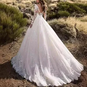 Elegant white lace long-sleeve wedding dress featuring an open back and long floral train.