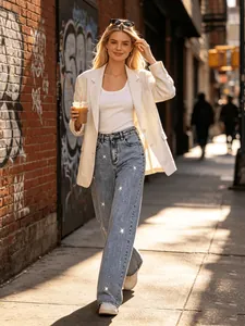 Model wearing light blue high-waisted wide-leg jeans with subtle star embellishments
