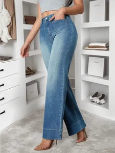 Detailed macro view of vintage blue wide-leg jeans with front pocket design in a closet.