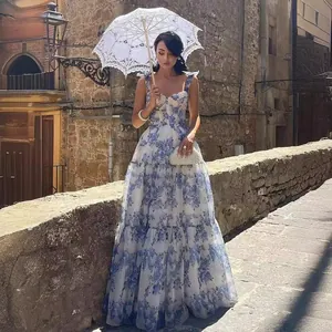 Elegant organza maxi dress with blue floral print featuring a romantic lace umbrella