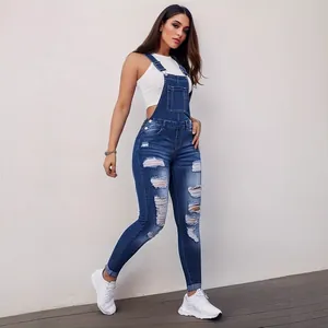Women's slim fit distressed denim overalls featuring ripped details and stretch fabric