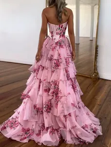 Detail of pink tiered ruffles and floral print on an elegant strapless evening gown