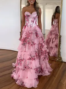 Close-up detail of pink floral tiered ruffled prom dress with strapless corset bodice