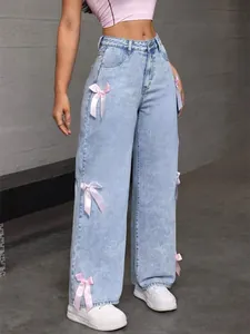High-waisted wide-leg light blue denim jeans with cute pink bow details on the sides