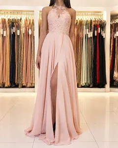 Elegant pink halter neck lace and chiffon evening gown with high leg slit detail.