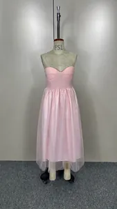 Elegant light pink corset style mesh dress with layered tulle skirt on dress form
