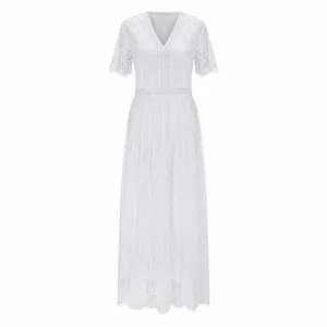 Elegant white lace maxi dress with deep V-neck and delicate hollow-out waist details.