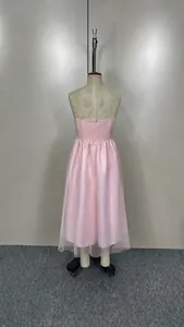 Rear view of a pink spaghetti strap tulle dress displayed on a dress form