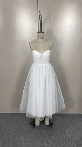 Front view of a white spaghetti strap mesh dress on a mannequin for detail display