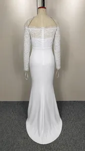 Back view of elegant white off-shoulder lace long-sleeve floor-length mermaid wedding gown.