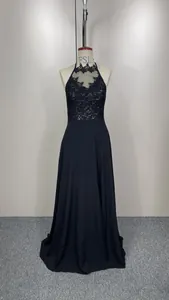 Detailed view of an elegant black halter neck lace evening gown with sequin bodice.