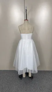 Detailed rear view of a white spaghetti strap tulle dress with back zipper on mannequin