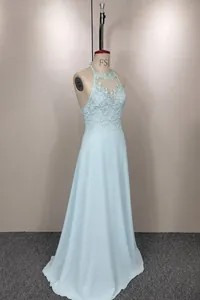 Angled detail shot of light blue halter dress on mannequin showing lace embroidery texture