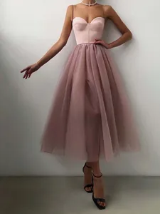Elegant mauve spaghetti strap mesh midi dress with a structured corset bodice and tulle skirt