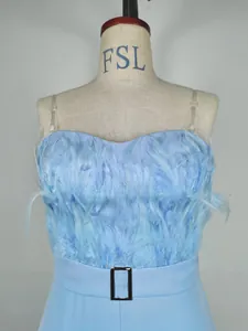 Close-up of light blue jumpsuit featuring fluffy feathers and a black buckle belt