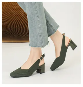 Detail view of dark green knitted square-toe block heel slingback sandals worn by model.