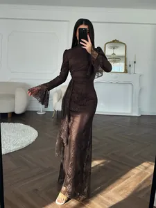 Model posing in an elegant brown lace bodycon evening gown within a luxury interior
